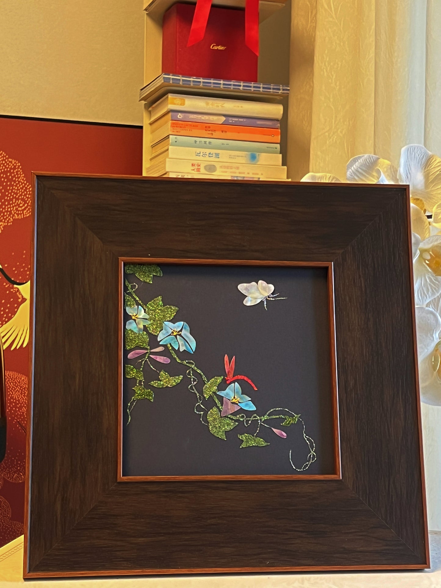 Original Raden shell art titled The Morning Glory by Showing Studio in a 35x35cm wide margin dark walnut frame, showcasing icy blue mother of pearl blossoms, a white shell butterfly, and a crimson dragonfly