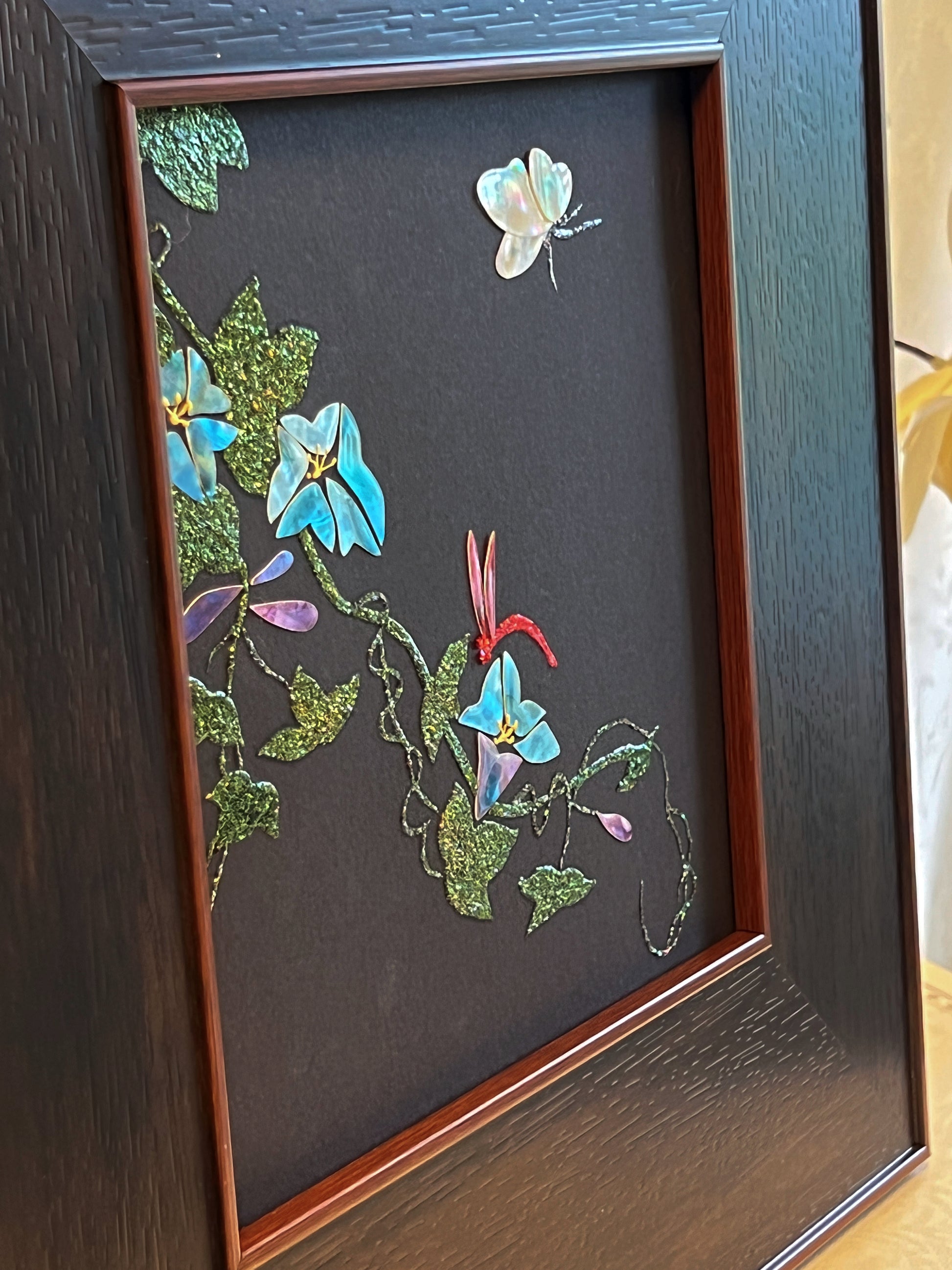 Original Raden shell art titled The Morning Glory by Showing Studio in a 35x35cm wide margin dark walnut frame, showcasing icy blue mother of pearl blossoms, a white shell butterfly, and a crimson dragonfly