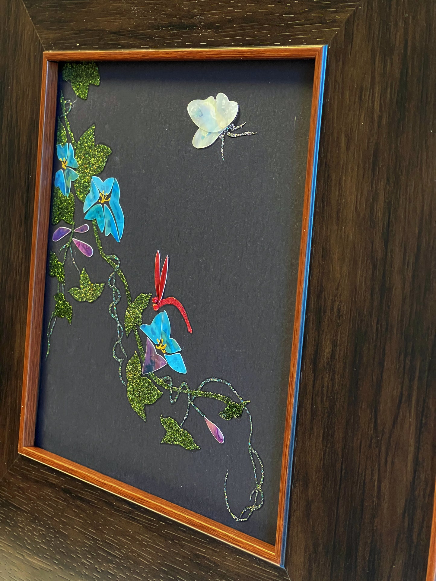 Original Raden shell art titled The Morning Glory by Showing Studio in a 35x35cm wide margin dark walnut frame, showcasing icy blue mother of pearl blossoms, a white shell butterfly, and a crimson dragonfly