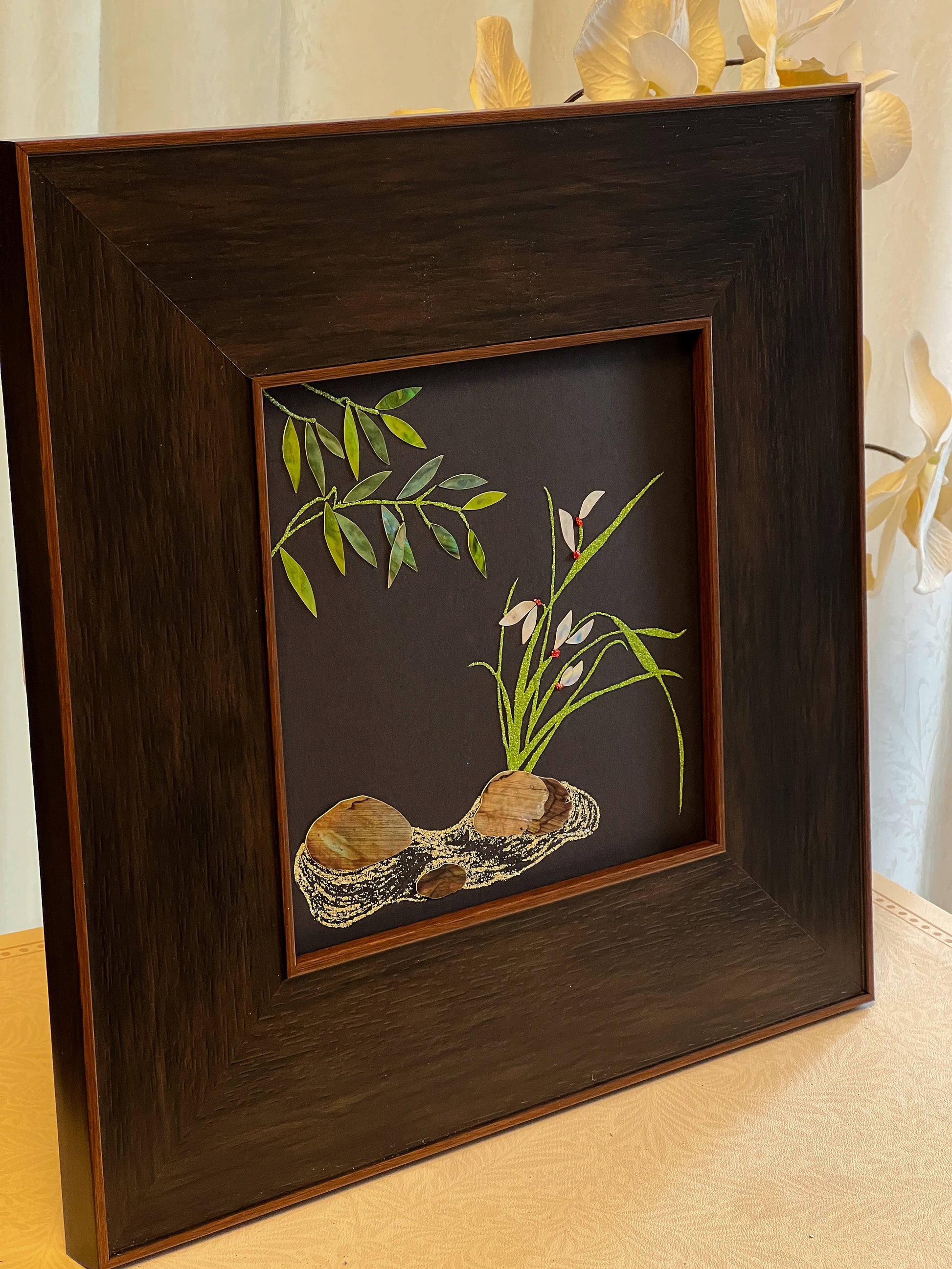 Original Raden shell art Lan Zhu Shuang Qing by Showing Studio in a 35x35cm walnut frame, showing deep green abalone bamboo leaves, ivory mother of pearl orchids and textured tiger shell rocks.