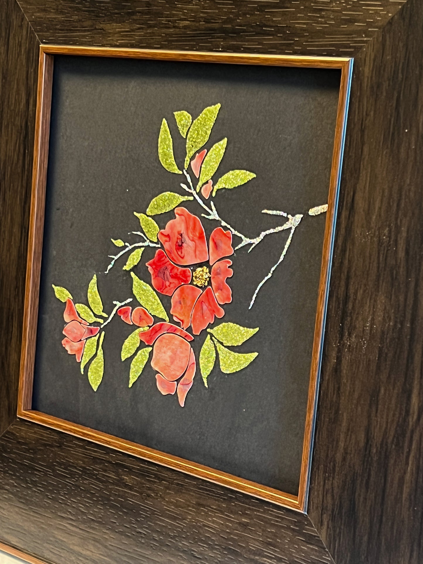 Original Raden shell art titled The Pomegranate Blossom by Showing Studio in a 35x35cm wide margin dark walnut frame, showcasing iridescent crimson mother of pearl petals and gold-lime abalone leaves
