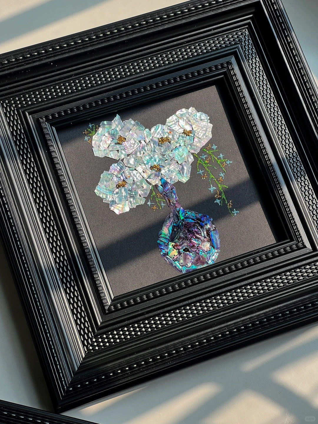 Close-up details of natural mother of pearl shell inlay craft, iridescent shell texture in lacquer art, fine oriental craftsmanship.