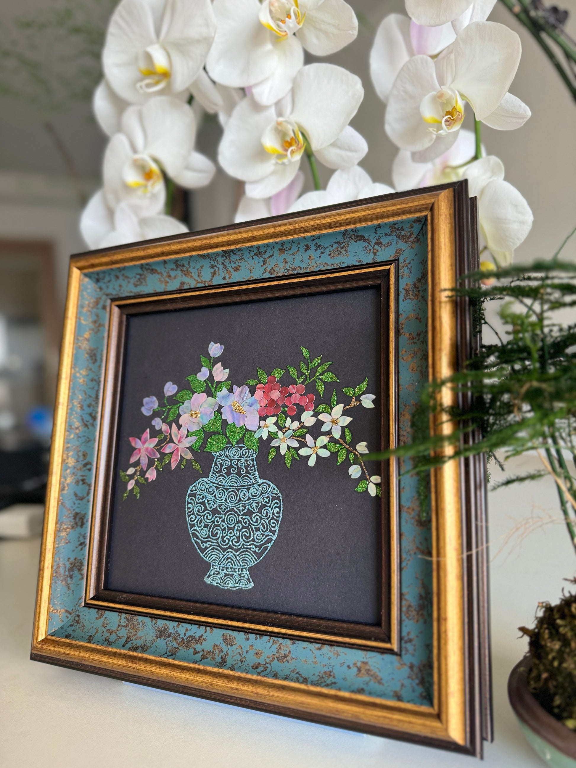 Macro photograph of traditional Raden inlay artistry showing the natural iridescent textures and multi-colored shimmers of mother-of-pearl shell petals and crystalline vase pattern.