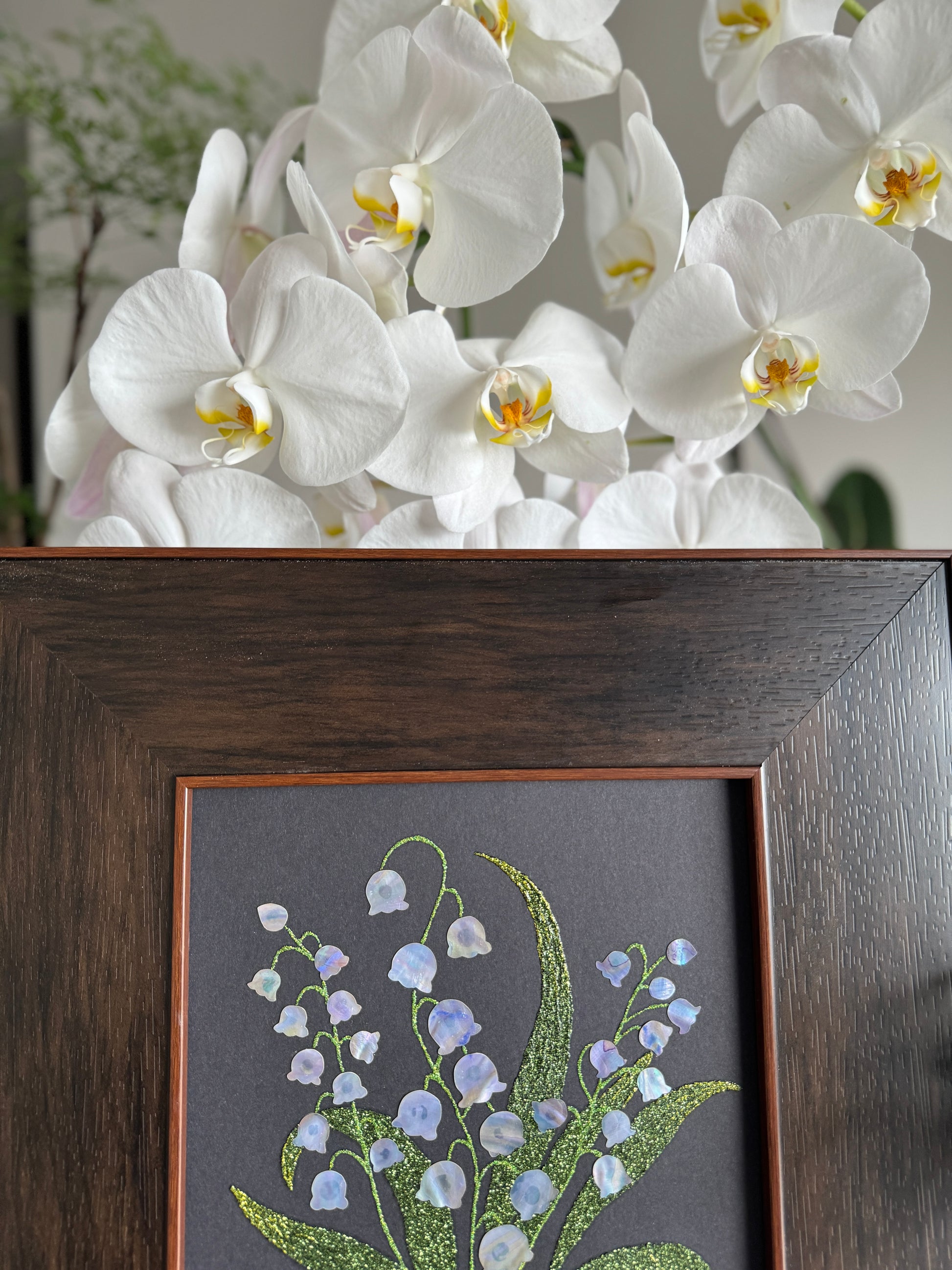 Handcrafted "Whispers of Lily" mother-of-pearl wall art, 20x20cm floral inlay, luxury botanical Zen home decor.