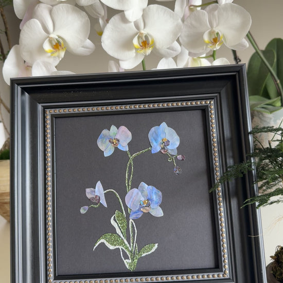 Original abstract Raden shell art titled The Azure Rhythm by Showing Studio in a 29x29cm dark walnut frame, showcasing shimmering green and blue abalone inlay waves on a black background.