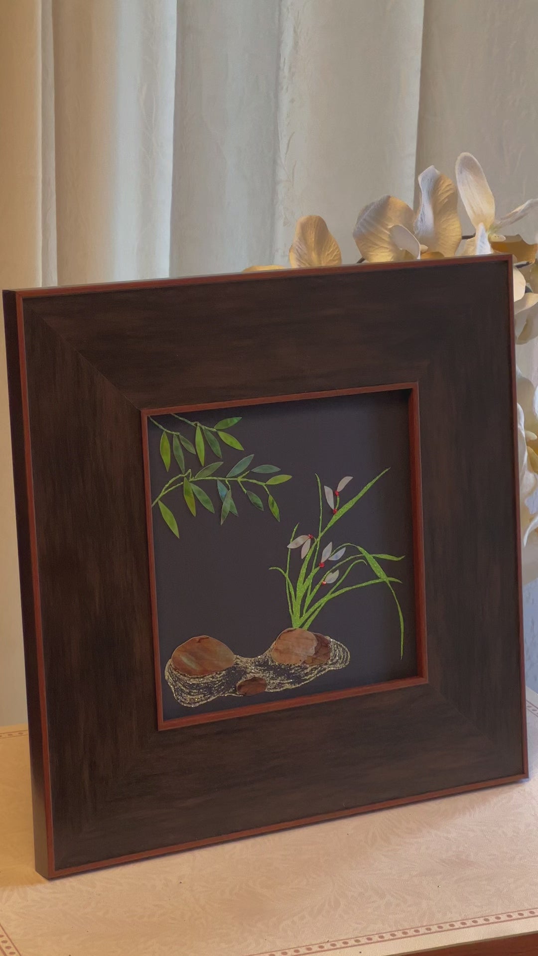 Original Raden shell art Lan Zhu Shuang Qing by Showing Studio in a 35x35cm walnut frame, showing deep green abalone bamboo leaves, ivory mother of pearl orchids and textured tiger shell rocks.