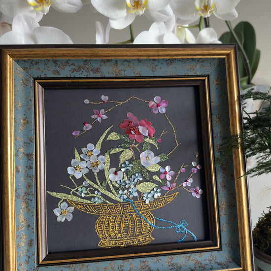 Luxury Zen home decor presentation featuring the "Three Friends of Winter" oriental shell artwork displayed next to a minimalist green kokedama bonsai plant.