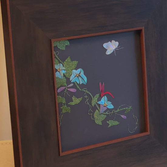 Original Raden shell art titled The Morning Glory by Showing Studio in a 35x35cm wide margin dark walnut frame, showcasing icy blue mother of pearl blossoms, a white shell butterfly, and a crimson dragonfly
